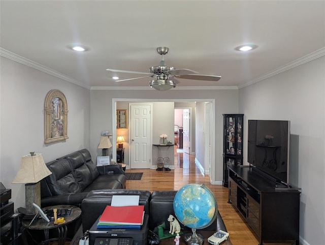 living area featuring a ceiling fan, baseboards, light wood finished floors, ornamental molding, and recessed lighting