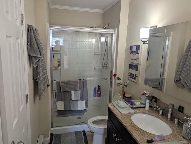 bathroom with crown molding, vanity, a shower stall, and toilet