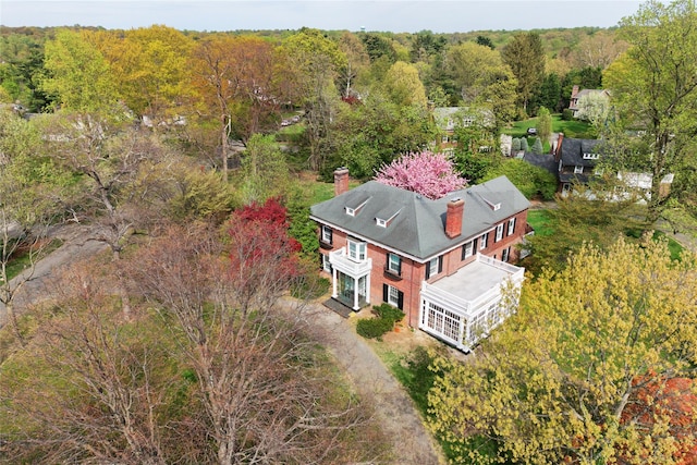 bird's eye view with a wooded view