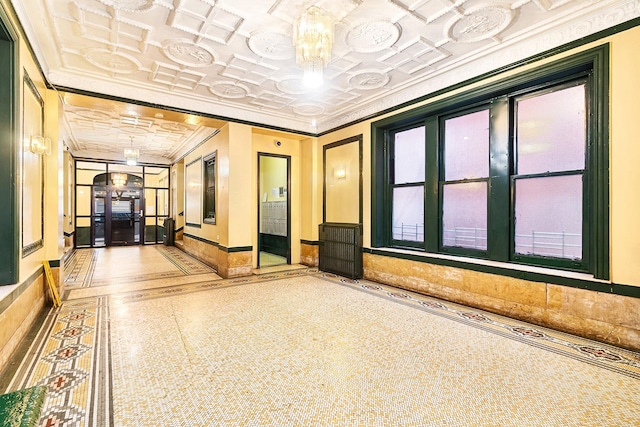 common area with an ornate ceiling and ornamental molding