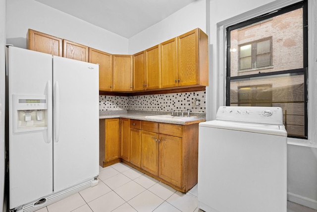 laundry area with washer / clothes dryer and light tile patterned flooring