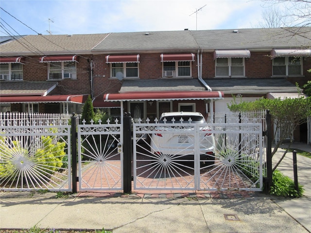 3922 Ely Ave, Bronx, NY 10466 - view of front of home featuring brick siding, a fenced front yard, and a gate