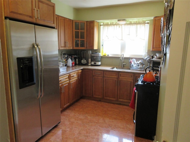 3922 Ely Ave, Bronx, NY 10466 - kitchen with brown cabinets, a sink, gas stove, decorative backsplash, and stainless steel refrigerator with ice dispenser