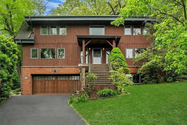 38A Claremont Rd, Scarsdale, NY 10583 - view of front facade with an attached garage, a front lawn, and driveway