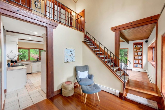 38A Claremont Rd, Scarsdale, NY 10583 - stairway with baseboard heating, hardwood / wood-style flooring, beam ceiling, and baseboards