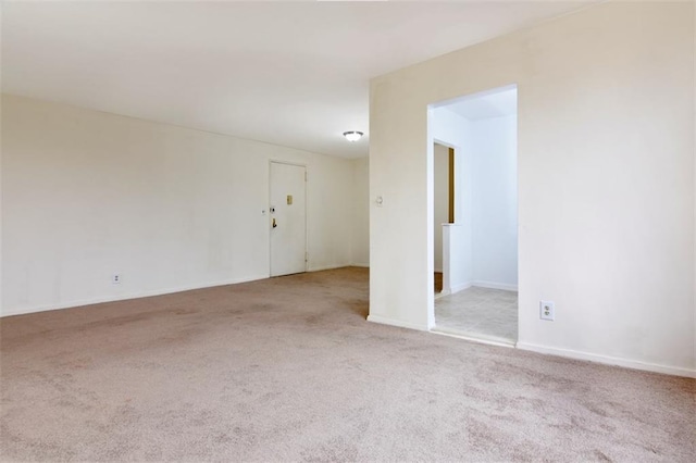 spare room with baseboards and carpet