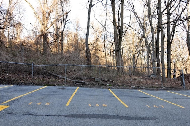 uncovered parking lot featuring fence
