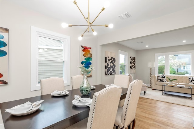 dining room featuring an inviting chandelier, light wood finished floors, visible vents, and recessed lighting