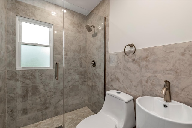 bathroom featuring a sink, tile walls, a stall shower, and toilet