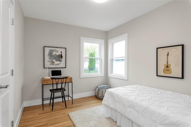 bedroom featuring wood finished floors and baseboards