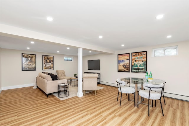 interior space with baseboards, light wood-type flooring, baseboard heating, and recessed lighting