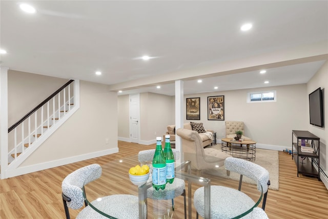 dining area with light wood-style flooring, stairs, baseboards, and recessed lighting