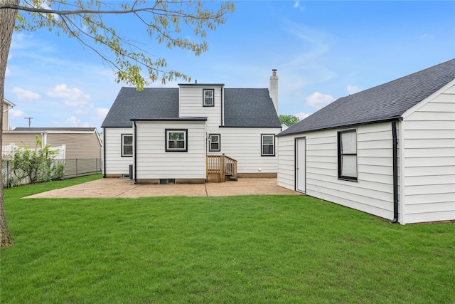 rear view of house featuring fence, a yard, a patio, a chimney, and a shingled roof