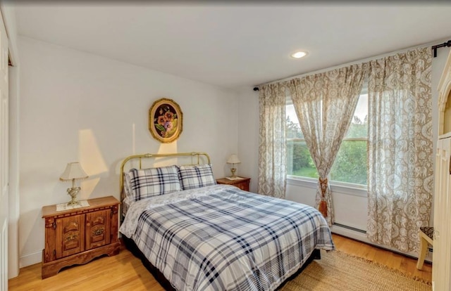 bedroom with light wood-style floors and recessed lighting