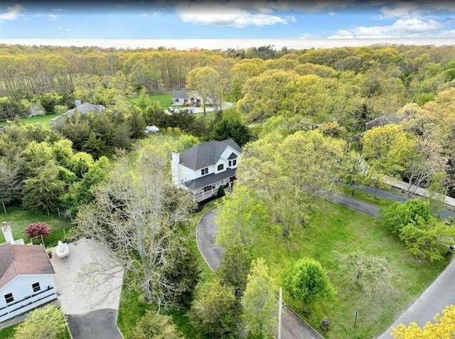 drone / aerial view featuring a view of trees