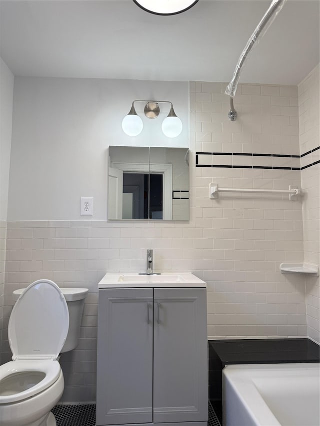 full bath with tile walls, vanity, and toilet
