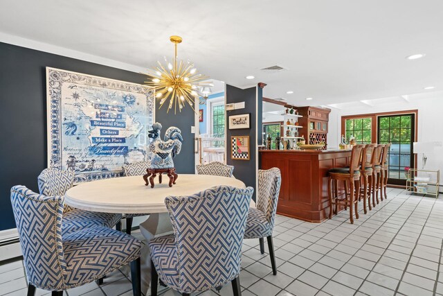 dining area featuring a chandelier, light tile patterned floors, a bar, and recessed lighting