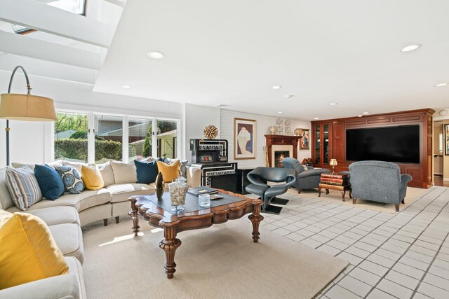 living area with recessed lighting, a lit fireplace, and light tile patterned floors