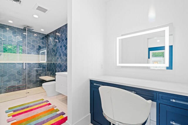 bathroom featuring a stall shower, vanity, toilet, and recessed lighting