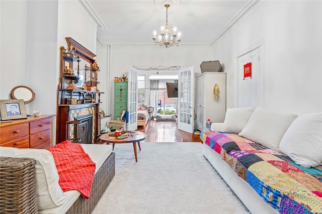 2504 21st St, Astoria, NY 11102 - bedroom with crown molding, a notable chandelier, french doors, and a fireplace