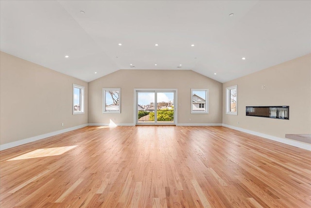 56 Oregon St, Long Beach, NY 11561 - unfurnished living room with a glass covered fireplace, lofted ceiling, baseboards, recessed lighting, and light wood finished floors