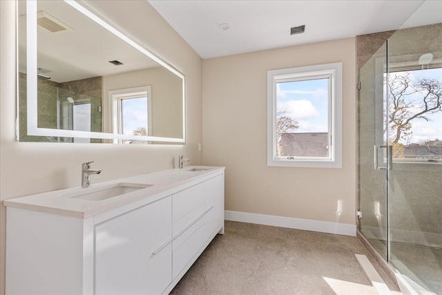 56 Oregon St, Long Beach, NY 11561 - bathroom with baseboards, a sink, a healthy amount of sunlight, and a shower stall