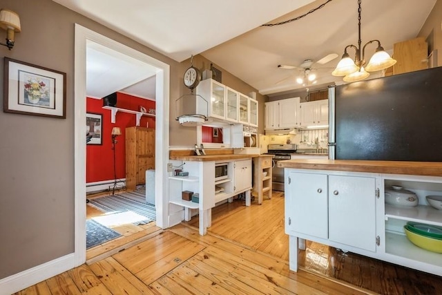 kitchen featuring open shelves, appliances with stainless steel finishes, butcher block counters, and light wood-style floors