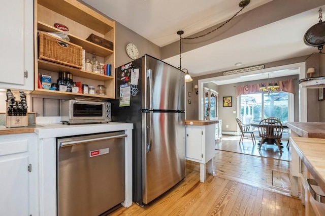 kitchen with stainless steel appliances, open shelves, white cabinetry, and light wood-style flooring