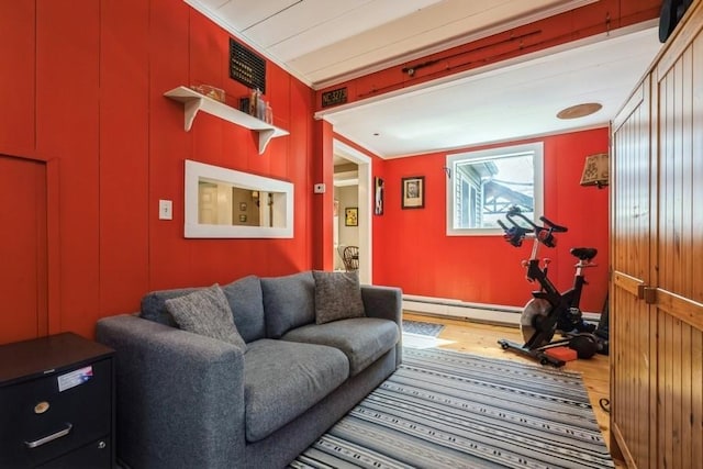 living area featuring baseboard heating and wood finished floors