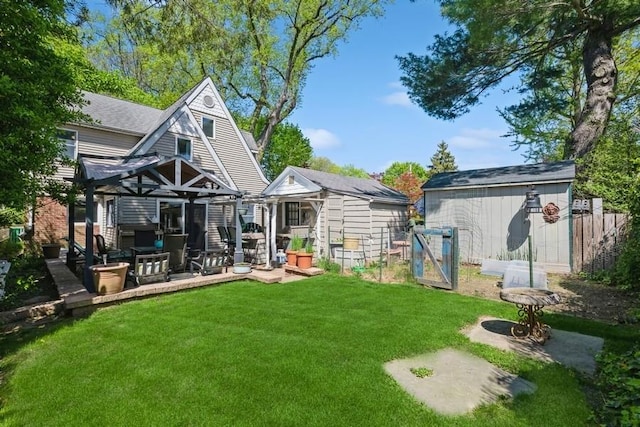 rear view of property with a lawn and an outdoor structure