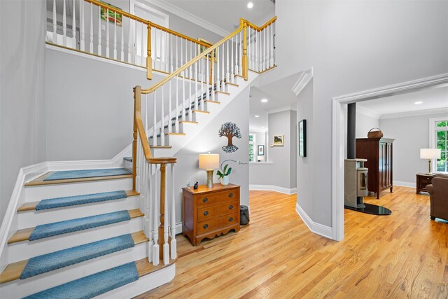 30 Warwick Lake Pkwy, Warwick, NY 10990 - stairway featuring wood finished floors, crown molding, a high ceiling, baseboards, and recessed lighting