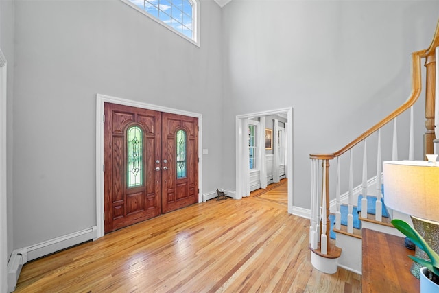 30 Warwick Lake Pkwy, Warwick, NY 10990 - foyer featuring stairs, a high ceiling, wood finished floors, baseboard heating, and baseboards