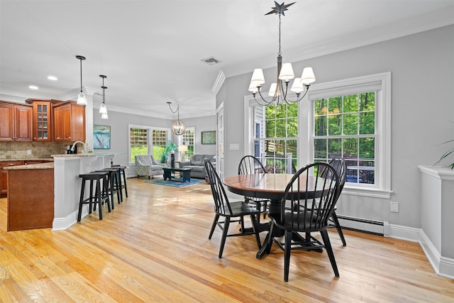 30 Warwick Lake Pkwy, Warwick, NY 10990 - dining space featuring a chandelier, ornamental molding, light wood finished floors, baseboard heating, and baseboards