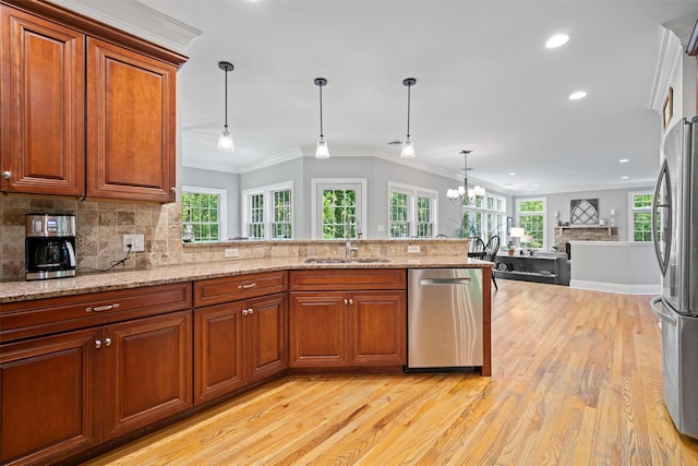 30 Warwick Lake Pkwy, Warwick, NY 10990 - kitchen with stainless steel appliances, a sink, crown molding, light wood-style floors, and decorative backsplash