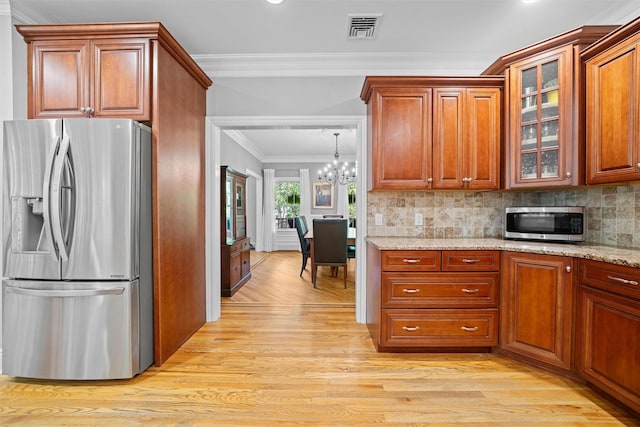30 Warwick Lake Pkwy, Warwick, NY 10990 - kitchen featuring appliances with stainless steel finishes, light wood-style flooring, crown molding, a chandelier, and glass insert cabinets