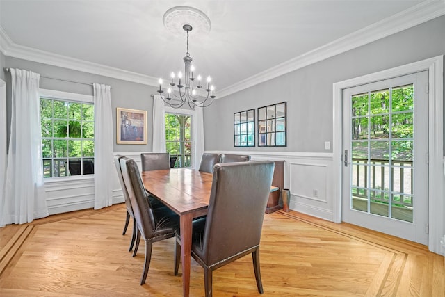 30 Warwick Lake Pkwy, Warwick, NY 10990 - dining area featuring a chandelier, crown molding, light wood-type flooring, wainscoting, and a decorative wall