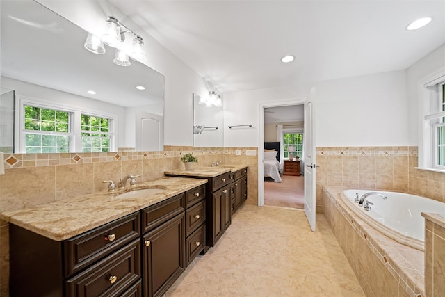 30 Warwick Lake Pkwy, Warwick, NY 10990 - ensuite bathroom featuring tile walls, vanity, a garden tub, recessed lighting, and wainscoting