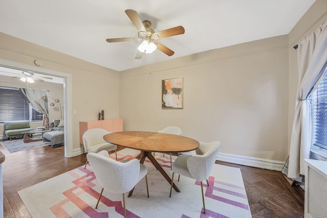 dining area featuring baseboards and a ceiling fan
