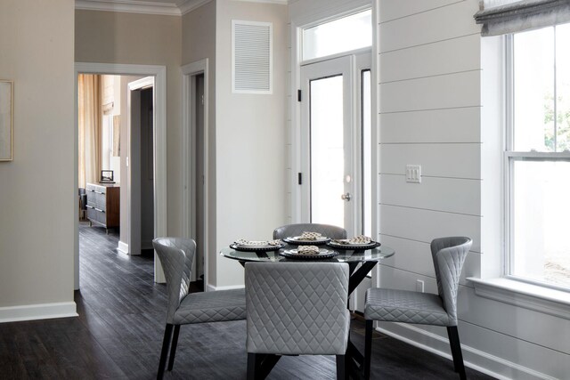 1239 Old Nichols Rd Unit 46, Islandia, NY 11749 - dining area with baseboards, dark wood finished floors, crown molding, and visible vents