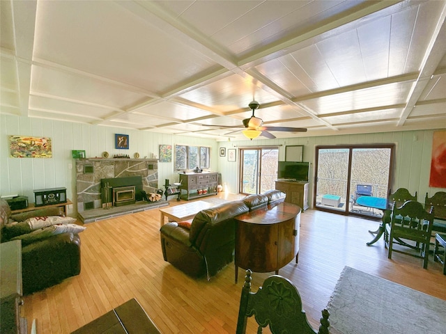living area with coffered ceiling and hardwood / wood-style flooring