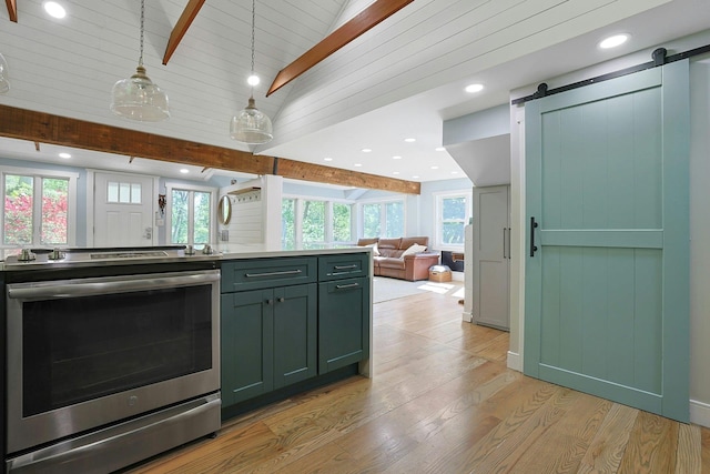 kitchen with stainless steel electric stove, a barn door, open floor plan, light wood-style floors, and green cabinetry