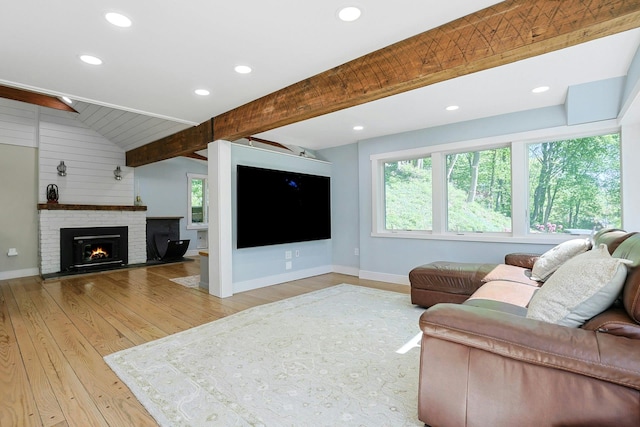 living room with wood finished floors, baseboards, recessed lighting, and a brick fireplace