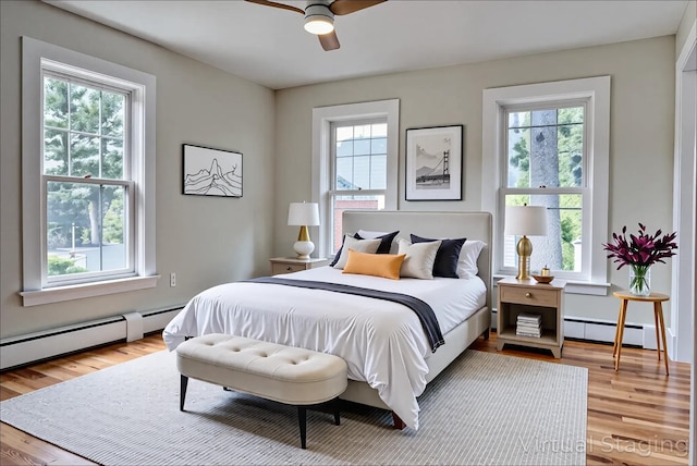 71 Lenox Ave, Congers, NY 10920 - bedroom with a baseboard radiator, multiple windows, and wood finished floors