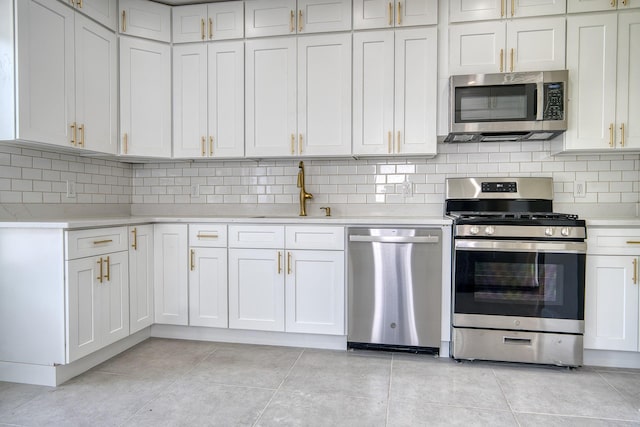 71 Lenox Ave, Congers, NY 10920 - kitchen with stainless steel appliances, a sink, light countertops, and decorative backsplash