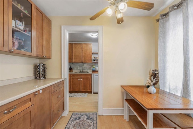 interior space featuring a sink, light wood-style floors, and a ceiling fan