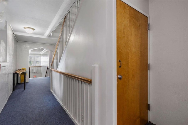 corridor featuring carpet and an upstairs landing