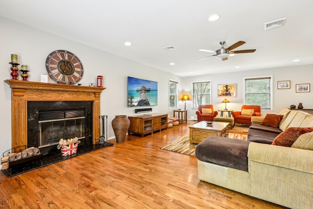 living area featuring recessed lighting, ceiling fan, visible vents, and wood finished floors