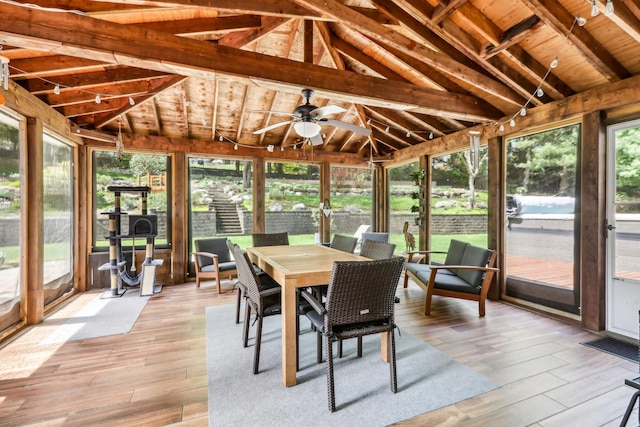 sunroom / solarium with a ceiling fan, hardwood / wood-style floors, wood ceiling, outdoor dining area, and lofted ceiling with beams