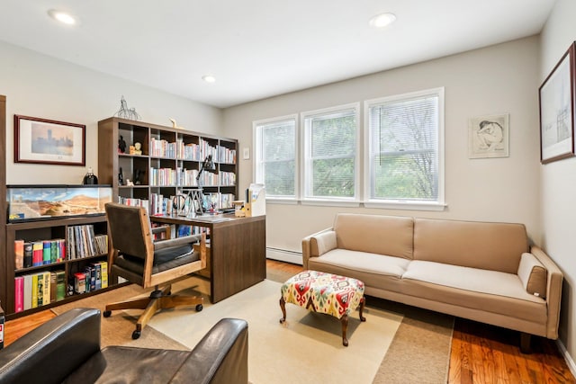 office space with wood finished floors, recessed lighting, and a baseboard heating unit
