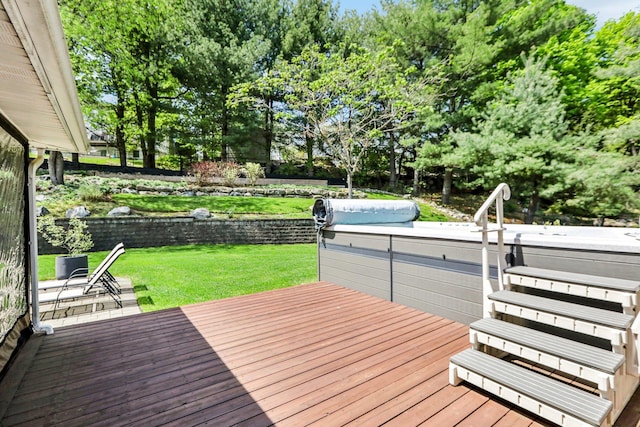 deck featuring a lawn, a hot tub, and fence
